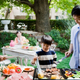 Father cooking on outdoor grill with children